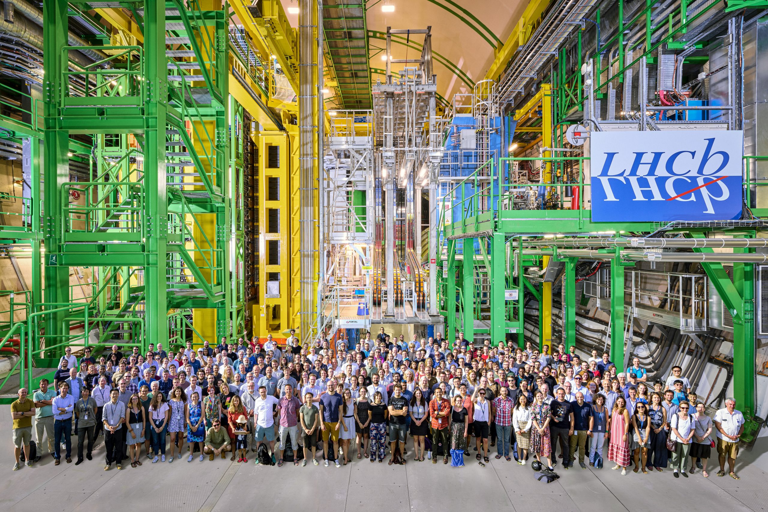 LHCb scientist posing in front of the LCHb experiment at CERN