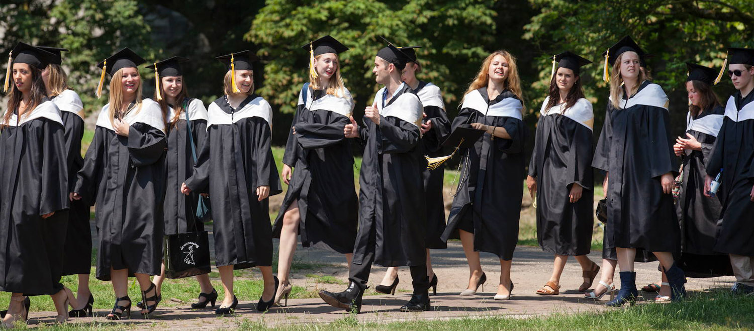 Graduates in caps and gowns walking together