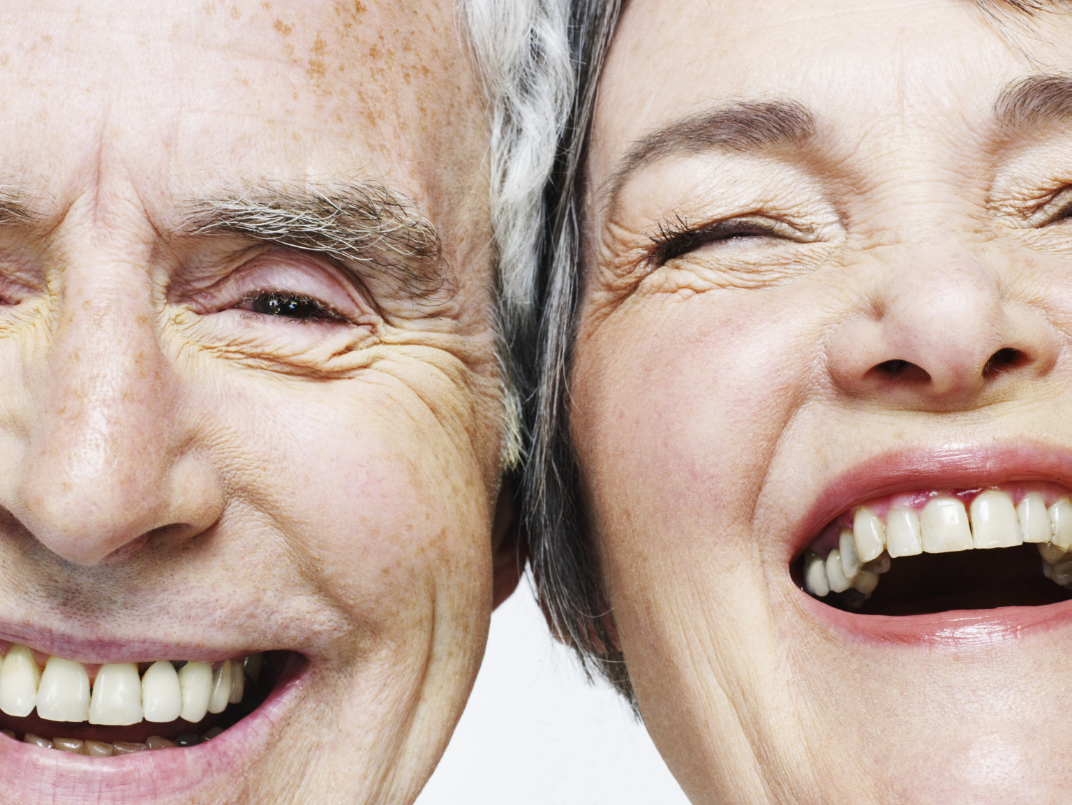 A picture of two elderly people laughing.
